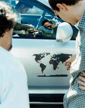 Man Pointing To Map On Cardoor