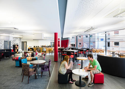 Student's in the cafe at Surrey University Campus, designed by Scott Brownrigg, Guildford, UK.