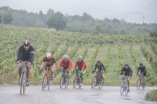 Eroica is a cycling event that takes place since 1997 in the province of Siena with routes that take place mostly on dirt roads with vintage bicycles. Usually it held on the first Sunday of October. This is a photo of cyclist who are riding in the rain.