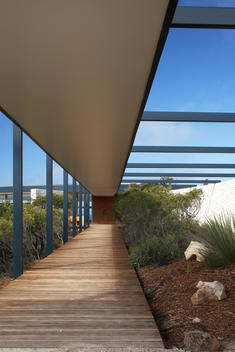 Covered Wood Walkway To Ocean View Rooms, Blue Sky Background - Southern Ocean Lodge