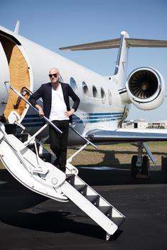Man Standing On Steps Of Private Jet, Fort Lauderdale, Florida, Usa