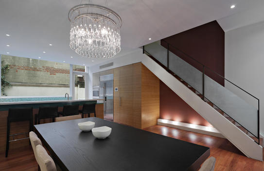 Dining Room With Long Wood Table, Chandelier, Kitchen Island With Leather Stools, Frosted Glass And Iron Railed Stairway