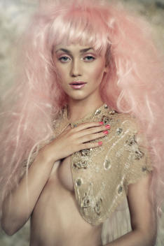 Young model wearing a pastel pink wig