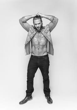 portrait of man nude from waist up. Muscles, well built. Stubble. Tattoos. Hipster. Rocker. Rebel. Full body, studio