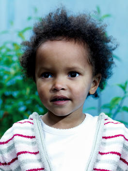 Portrait Of A Very Young Girl With Curly Hair, Mixed Race Appearance