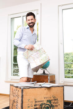 man with beard casual living room with map