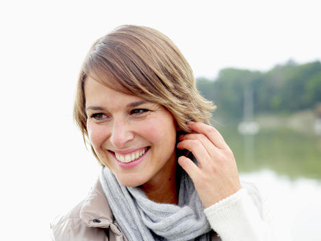 Germany, Munich, Mature woman in warm clothing, smiling