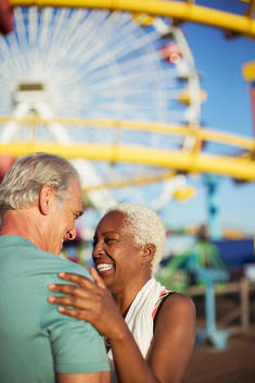 Enthusiastic senior couple at amusement park