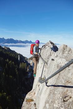 Woman mountain-climbing, Tegelberg, Fuessen, Allgaeu, Germany