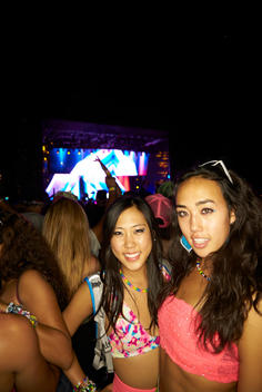 Two women in rave attire at a concert.