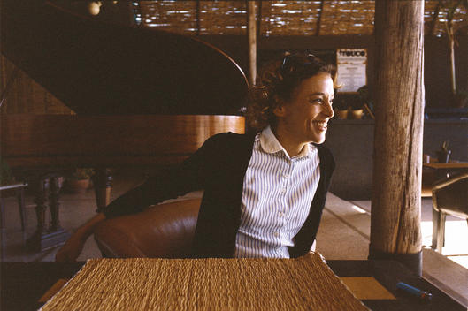 A portrait of woman seated at a table at the Fellah Hotel