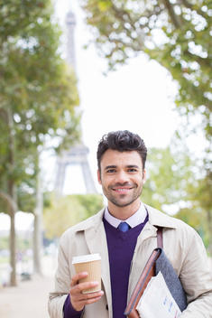 Businessman smiling in park near Eiffel Tower, Paris, France