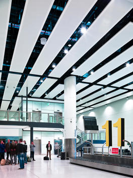 Passengers waiting for luggage at Gatwick North Terminal designed by Capita Symonds, London, UK.
