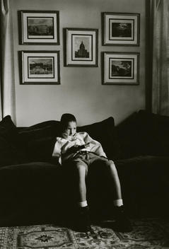 Boy watching TV holding remote