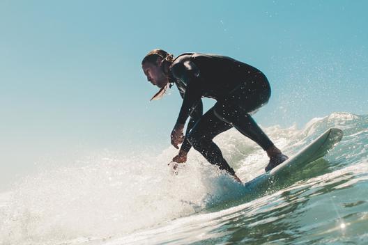 Young man surfing, low angle view