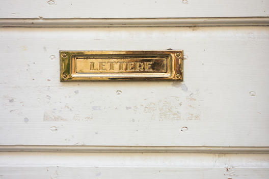 Brass Mail Slot on White Door