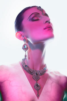 Model with jewelry in ethnic style. On the shoulders of the model are visible veins.