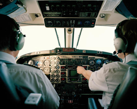 Cockpit View Of Two Pilots Operating An Airplane