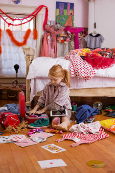 girl packing in messy room