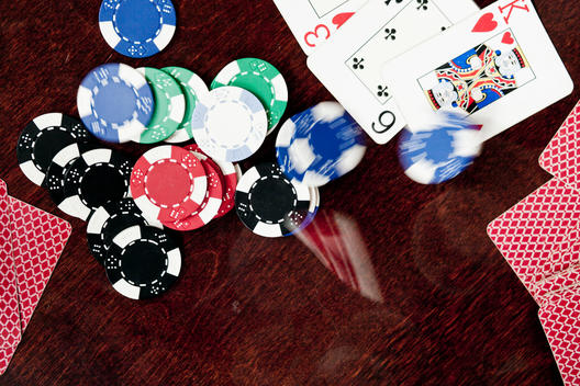 High angle view of gambling chips and playing cards on table