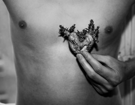Man Holding An Ornate Heart Shape To His Chest.