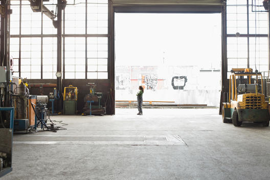 Hispanic worker standing in warehouse doorway