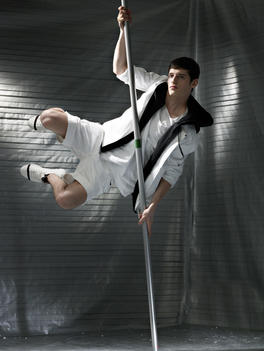 Fashion Story Male Model In A Grey Gaffer Tape Background Environment Suspended On A Pole In Mid Air