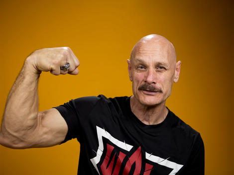 Arm wrestling competitor Allen Fisher flexes his muscles