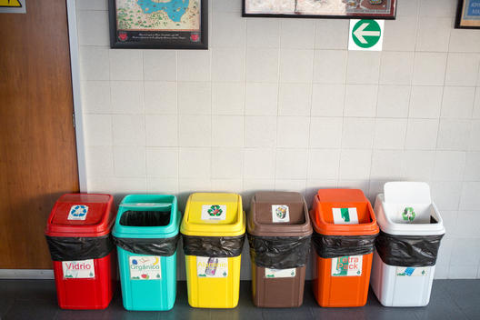 Trash bins lined up on a wall