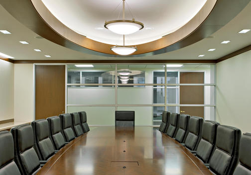 Conference Room With Fitted Oriental Carpet, Black Leather Chairs, Wood Trimmed Ceiling Fixtures, Glass Wall