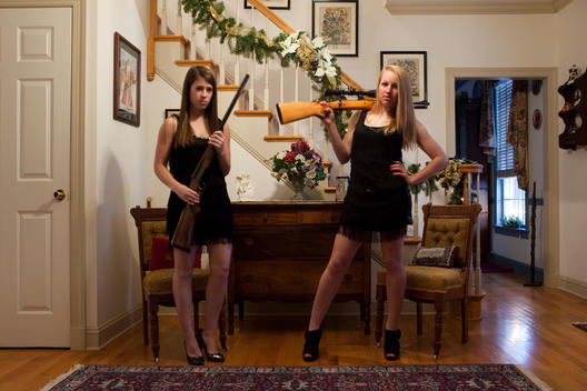 Teenage Girls Posing With Guns In The Living Room