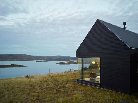 A timber house designed by the architecture firm Dualchas, owned by Neil and Alasdair Stephen. The site is an elevated bare croftland with view over Dunvegan bay to the Waternish peninsula. The design is directly inspired by a black shed on the adjacent c