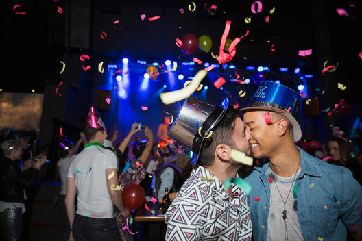 Homosexual couple kissing at New Year celebration
