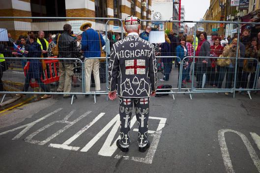 Back View Of Pearly King Of Highgate Looking At Barrier And Waiting Crowd Behind