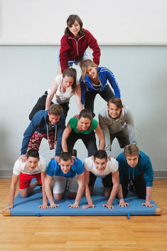 Germany, Berlin, Young people and teenager building human pyramid