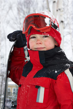 Caucasian boy wearing ski gear in snow