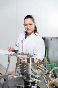 Portrait of female scientist, doing research on a innovative technology for mixing chemicals, at a hightech startup company