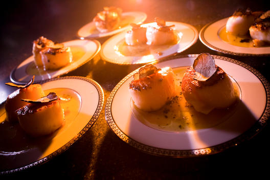 Scallops with slices of truffle are ready for serving at an indulgent New Years Eve meal.