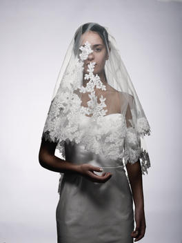 A portrait of a sad bride wearing a veil.