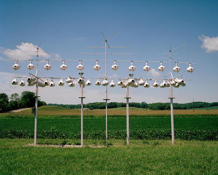 Rows Of Bird Feeders With Crops In The Background
