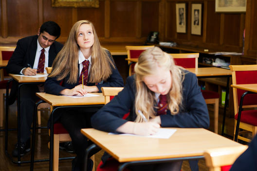 Group of teenage schoolchildren sitting exam