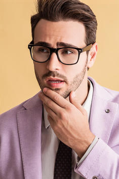 Man in purple suit jacket with glasses
