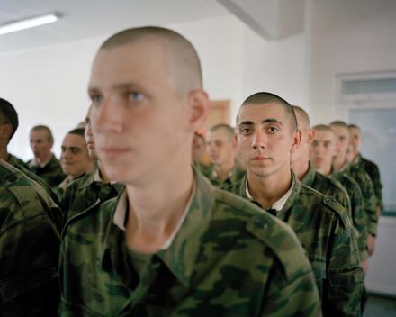 Russian Soldiers With Shaved Heads Wearing Camouflage Outfits Stand Ready For Inspection By Officers At The Kovrov Army Training Camp.