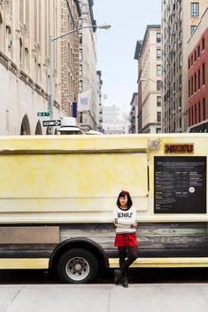 Female small business owner in front of his food truck