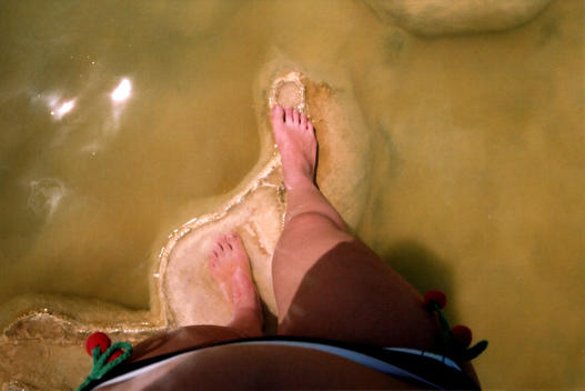 Looking down at feet in water