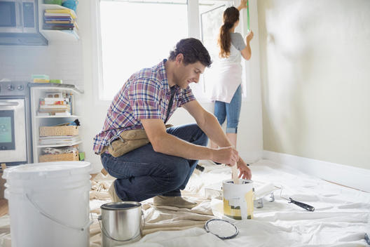 Couple starting painting project in living room