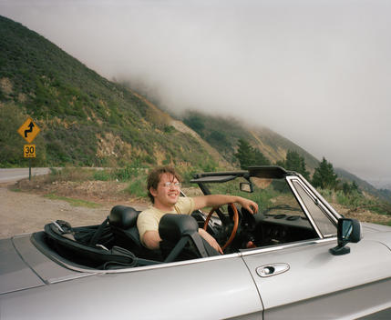 Man Driving In Convertible Along Highway One