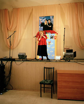 Elderly Woman Singing On Stage In A School In Omsk.
