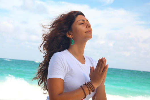 Female meditating on beach, Paradise Island, Nassau, Bahamas