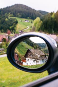 Black forest landscape scenery through the driving mirror